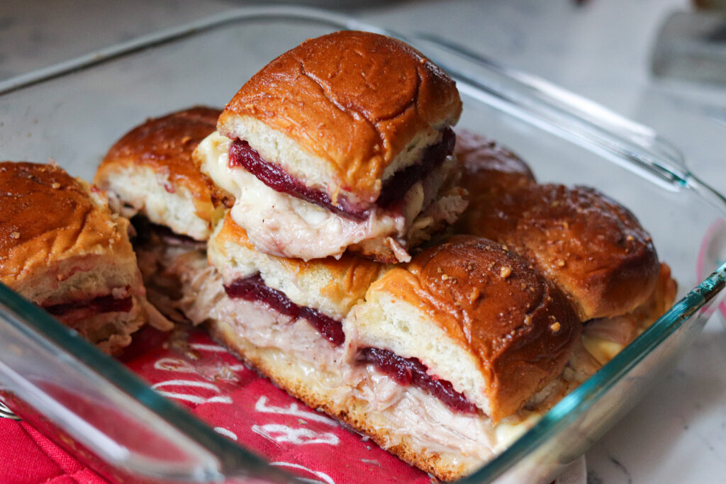 Turkey Cranberry Sliders are the ULTIMATE Thanksgiving leftovers meal! Packed with turkey, cranberry sauce and cheese, these sliders are so good!