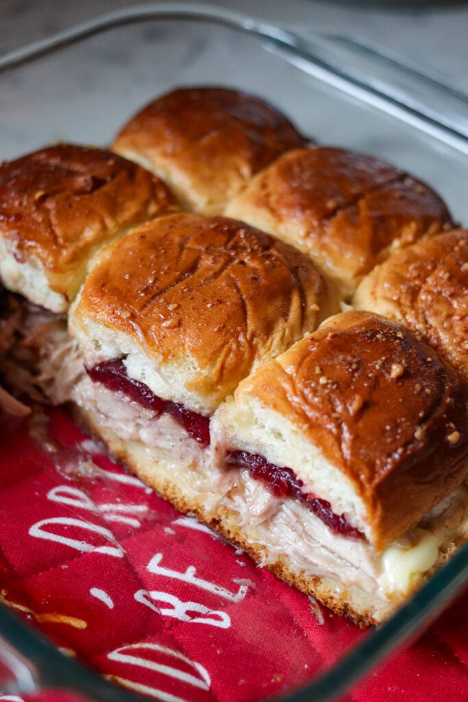 Turkey Cranberry Sliders are the ULTIMATE Thanksgiving leftovers meal! Packed with turkey, cranberry sauce and cheese, these sliders are so good!